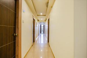 an empty corridor in a hospital with a door and a long hallway at FabHotel Raj Vihar Residency in Vijayawāda