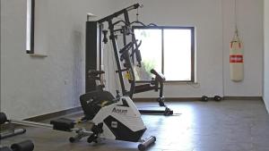 a gym with several tread machines in a room at Horta da Quinta in Mértola