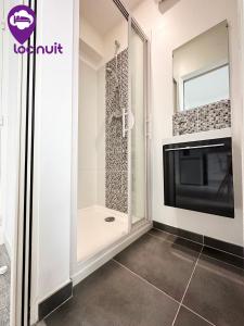 a shower with a glass door in a bathroom at Loc'Nuit - Appartements Tout Confort - Hyper Centre AGEN in Agen