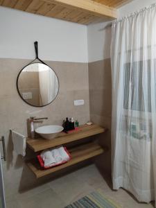 a bathroom with a sink and a mirror at Tra i Parchi in Pescina
