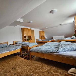 a large room with four beds in it at Adventure Farm in Štore
