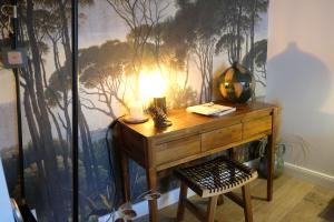 a desk in a room with a painting of trees on the wall at VILLA PIERARTLOU in Arès