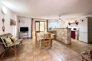 a kitchen and living room with a table and chairs at [Eleganza Rustica In Villa] A 5 minuti dal mare in Tonnara di Bonagia