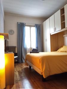 Un dormitorio con una cama grande y una ventana en La casetta di Elena - Sondrio Valtellina, en Sondrio