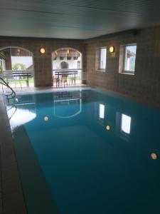 a large blue swimming pool in a house at Ferienwohnung Waldblick FEWO 502 in Freudensee