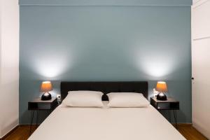 - une chambre avec un grand lit et 2 lampes sur les tables dans l'établissement Central Elegant Flat, à Patras