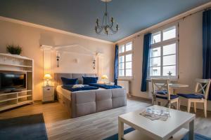 a bedroom with a bed and a living room at Villa Altstadtperle Erfurt in Erfurt
