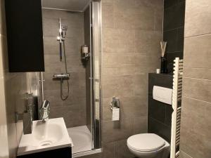 a bathroom with a shower and a toilet and a sink at Bed en Breakfast Romee in Epe +14 photos