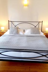 a bedroom with a large bed with white sheets and pillows at Boutique Hotel Templ in Mikulov