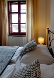 a bedroom with a bed and a window at Boutique Hotel Templ in Mikulov