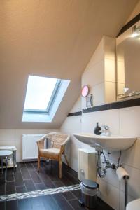 a bathroom with a sink and a skylight at Villa Altstadtperle Erfurt in Erfurt