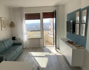 a living room with a couch and a television at LAMAR SUITES Seafront Apartments in Misano Adriatico