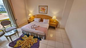 a hotel room with a bed and a balcony at Amarina Sun Resort & Aqua Park Sharm El-Sheikh in Sharm El Sheikh