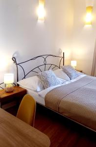 a bedroom with a bed with two lamps and a table at Boutique Hotel Templ in Mikulov