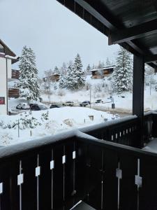 a view of a snow covered parking lot with cars parked at Carè Alto in Vason