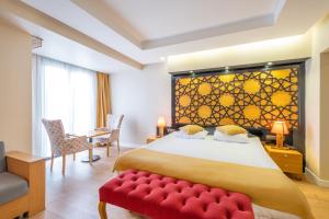 Suite Rooms By Vvrr في إسطنبول: غرفة نوم بسرير كبير ومقعد احمر
