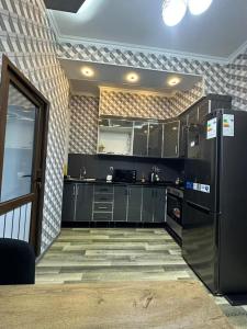 ドゥシャンベにあるApartment 2のキッチン(黒いキャビネット、黒い冷蔵庫付)