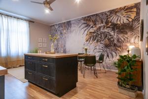 a kitchen with a island in the middle of a room at STING Boutique Apartments in Ostrava