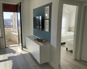a living room with a white cabinet and a mirror at LAMAR SUITES Seafront Apartments in Misano Adriatico +35 photos