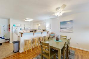 a kitchen and dining room with a table and chairs at Seven B Heaven in Rodanthe