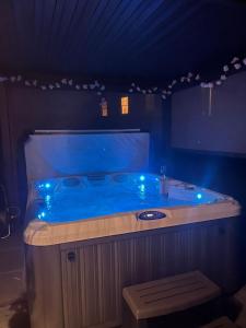 a large blue tub with blue lights in a room at Luxury home that sleeps up to 8 adults and 6 children - hot tub and parking for 4 cars in Bury Saint Edmunds