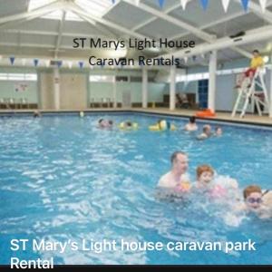 a group of people in a swimming pool at St Marys Light house, Caravan Rentals in Whitley Bay