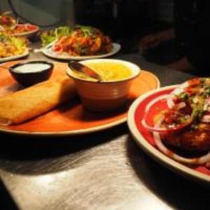 a table with plates of food on a table at Grove Residency Hauz Khas New Delhi Couple Friendly in New Delhi