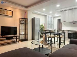 a living room with a couch and a table and a tv at Gtrip Monastiraki Cosy Apartment - 5026 in Athens