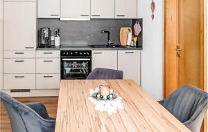 uma cozinha com uma mesa de madeira e 2 cadeiras em Beautiful Apartment In Mhlbach Am Hochknig With Kitchen em Mühlbach am Hochkönig