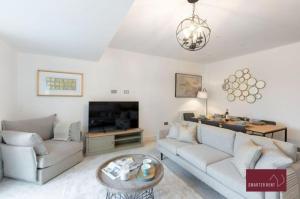 a living room with a couch and a tv at Sunbury-on-Thames - 4 Bed House in Sunbury Common