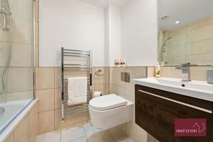 a bathroom with a toilet and a sink at Richmond - 1 Bedroom Apartment - With Garden in Kew
