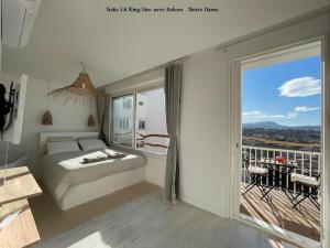 a bedroom with a bed and a large window at LaFrenchCasa Clandestina in Marseille