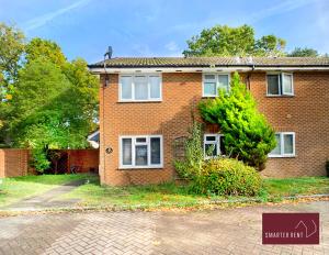 a brick house with a driveway in front of it at Lightwater - 1 Bedroom Terraced House in Bagshot