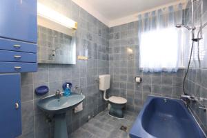 a bathroom with a blue tub and a toilet and a sink at Apartment in Silo/Insel Krk 14599 in Šilo
