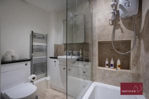 a bathroom with a shower and a toilet and a sink at Bracknell - 2 Bedroom Home With Parking & Garden in Easthampstead