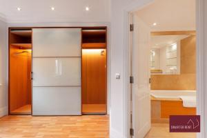 a kitchen with a white refrigerator in a room at Richmond - 5 Bedroom Townhouse with Parking & Garden in London