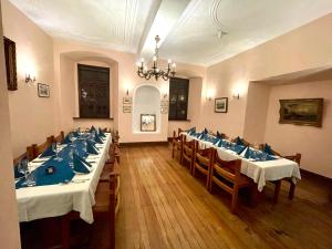 a large dining room with tables and chairs and a chandelier at Hotel Schloss Zell in Zell an der Mosel