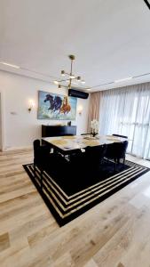 a dining room with a table and black chairs at Orion_apartments in Lagos