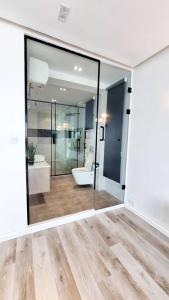 a bathroom with a toilet and a glass door at Orion_apartments in Lagos