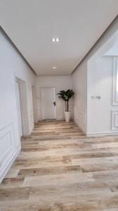 a room with a hallway with wooden floors and white walls at Orion_apartments in Lagos