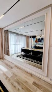 a large mirror in a living room with a piano at Orion_apartments in Lagos