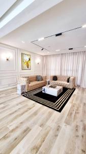 a large living room with two couches and a table at Orion_apartments in Lagos