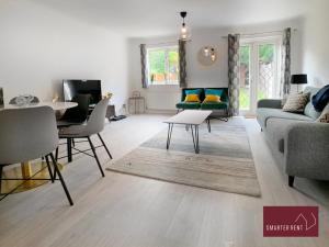 ein Wohnzimmer mit einem Sofa und einem Tisch in der Unterkunft Knaphill, Woking - 3 Bed House - With Garden in Brookwood