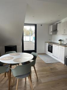 a kitchen with a table and some chairs and a table and a kitchen at Wohnung mit großer Dachterrasse in Aachen