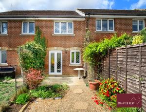 a brick house with a fence and a garden at Knaphill, Woking - 2 Bedroom House - Garden and Parking in Brookwood