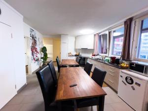 una cocina con una mesa de madera larga y sillas en Gery's Camp, en Lucerna