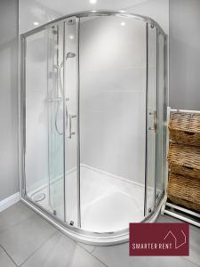 a shower with a glass enclosure in a room at Maidenhead- 3 Bedroom House With Garden in Maidenhead