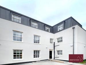 a white building with a black roof at Eton, Windsor - 1 Bedroom Ground Floor Apartment - With Parking in Eton
