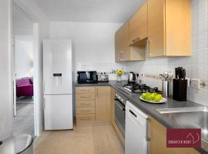 a kitchen with a white refrigerator and a sink at Bracknell - 2 Bedroom House With Garden and Parking in Easthampstead
