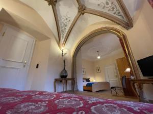 a bedroom with a bed with a large mirror at Hotel Schloss Zell in Zell an der Mosel